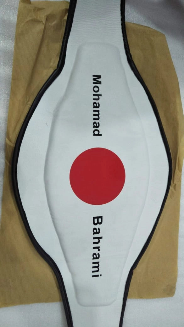Preparing to print athlete’s name on the back side of a personalized championship belt.