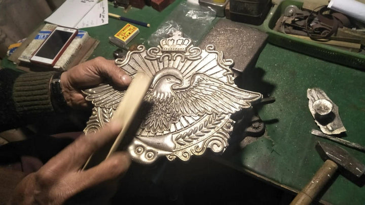 Cleaning and smoothing rough surface of belt plate before detailing.