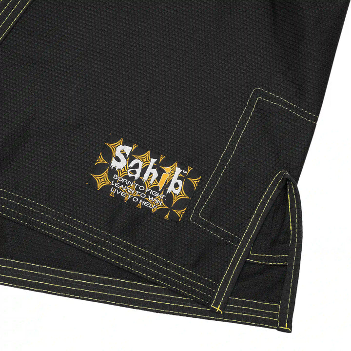 Close-up of contrast yellow stitching on black Sahib youth BJJ gi