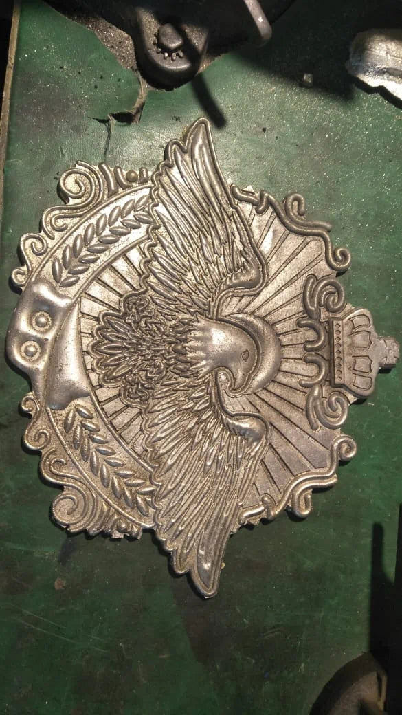Shaping a molten metal plate into final form before polishing for belt use.