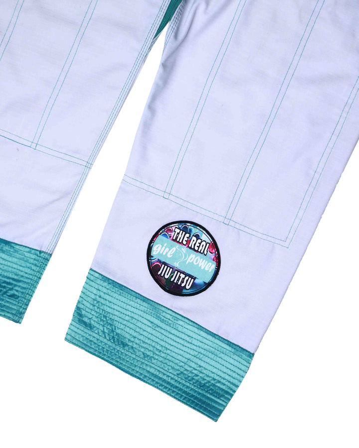 Close-up embroidery and sublimated patch on green Girl Power Jiu Jitsu Gi pants for women