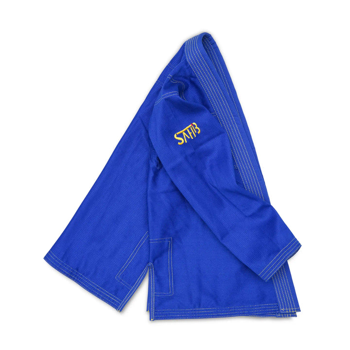 Side profile of young athlete in Sahib blue BJJ gi – grappling gear for kids