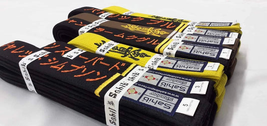 "Close-up of embroidered kyokushin karate belt with name and kanji