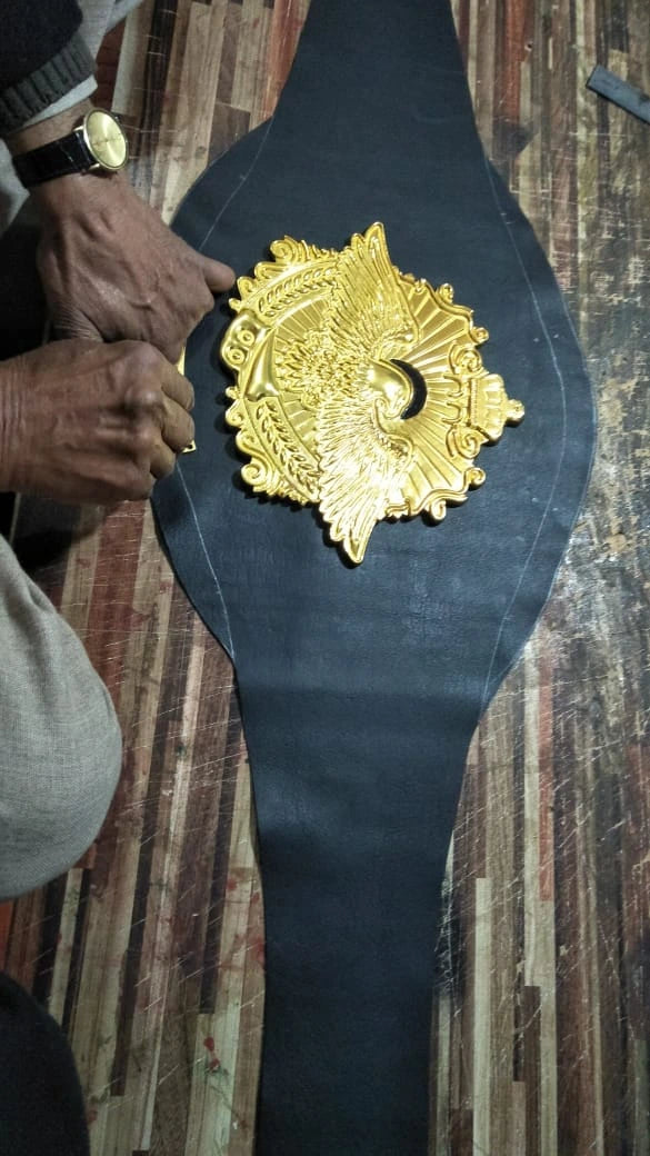 Drawing pattern outlines on leather strap for custom championship belt.