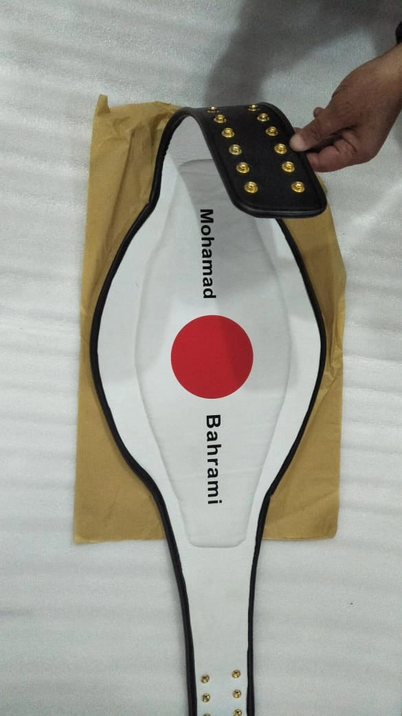 Custom name being printed onto the back of a championship belt under screen.