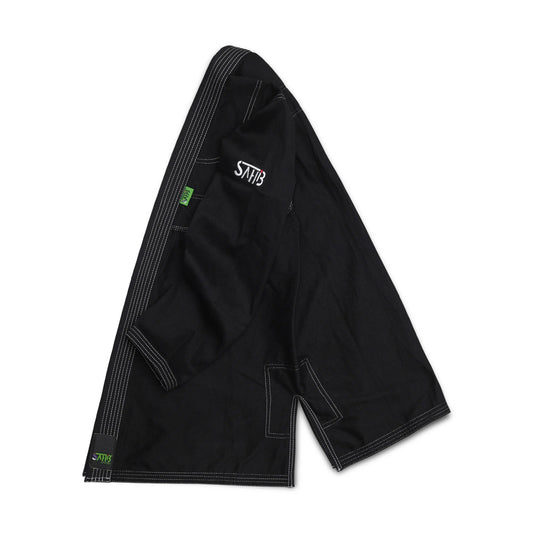 Side view of Sahib® UAE Series V2 black/white BJJ gi jacket – durable grappling uniform for daily rolling sessions